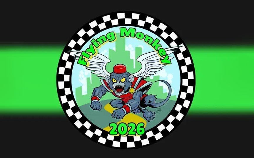 Circular “Flying Monkey” 2026 emblem with a fierce winged superhero monkey, city skyline, checkerboard border, and vivid green glow.